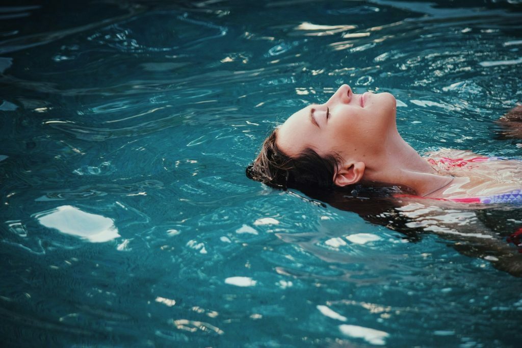 Woman floating on body of water haley-phelps-s-llxyh3gzi-unsplash-1024x683-2526343